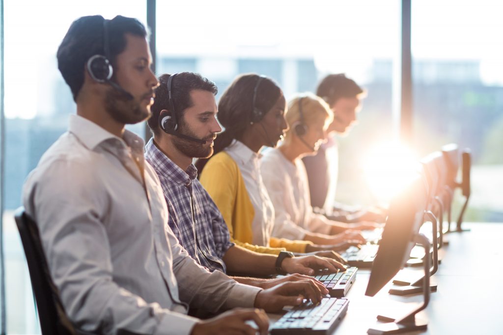 Team of colleagues working at their desk with headset
